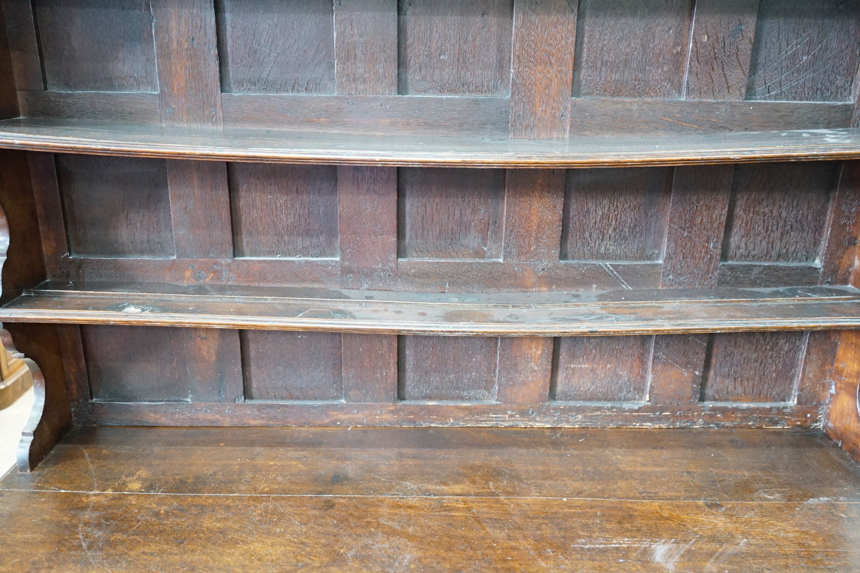 An 18th century oak dresser with boarded rack, width 150cm, depth 47cm, height 196cm